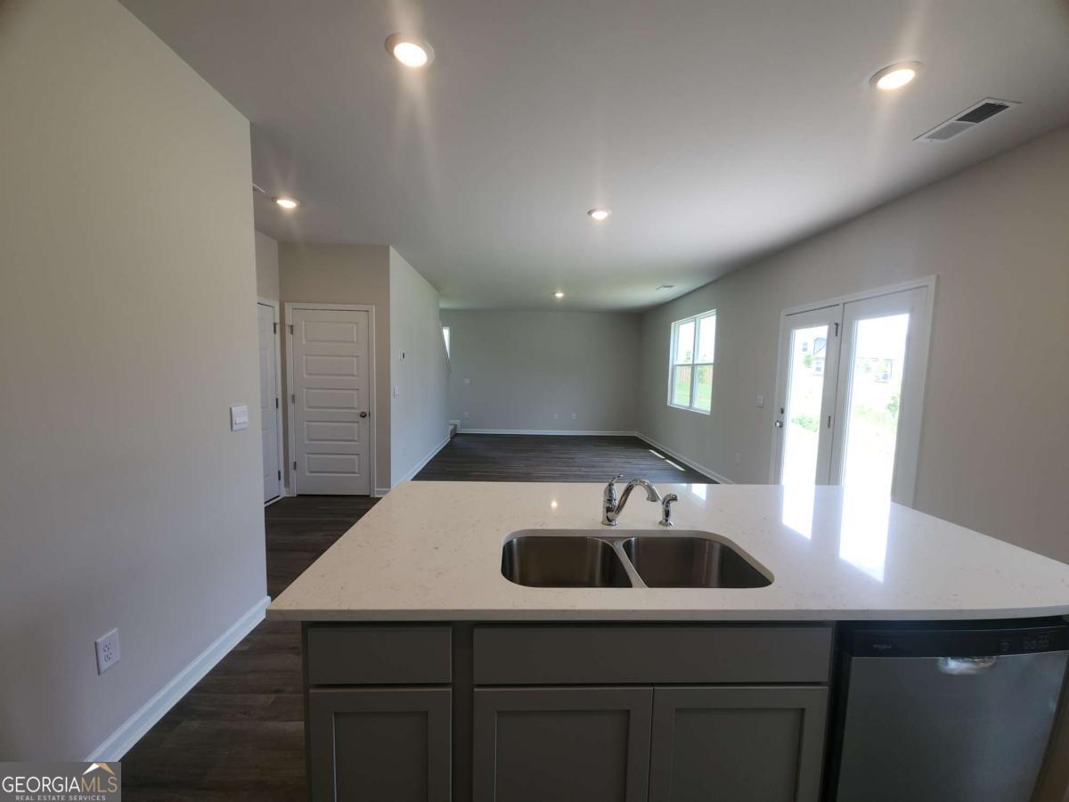146 Aster Avenue Locust Grove, GA 30248 - Photo 11 of 25 a kitchen with a sink and refrigerator