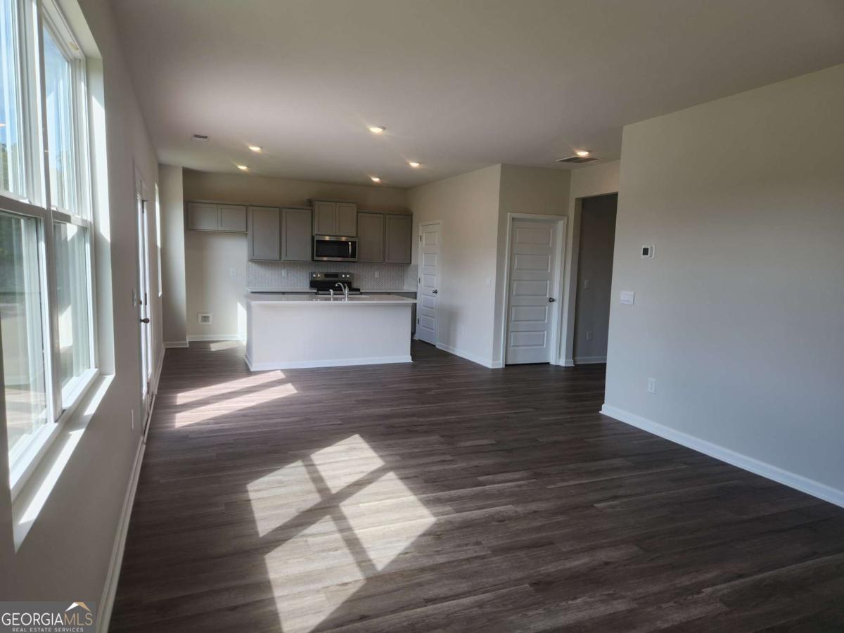 146 Aster Avenue Locust Grove, GA 30248 - Photo 3 of 25 a view of a kitchen with wooden floor and a window