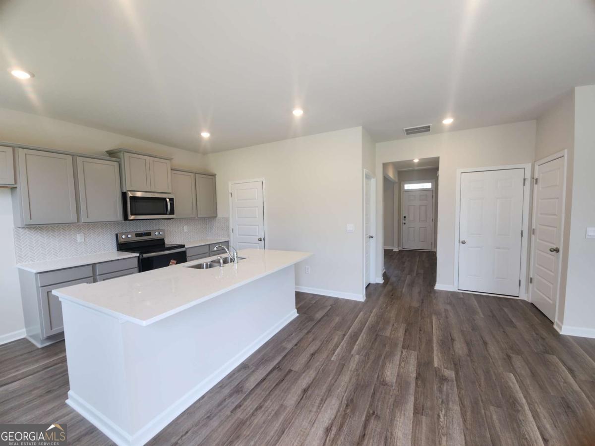 146 Aster Avenue Locust Grove, GA 30248 - Photo 6 of 25 a view of a kitchen with microwave and cabinets
