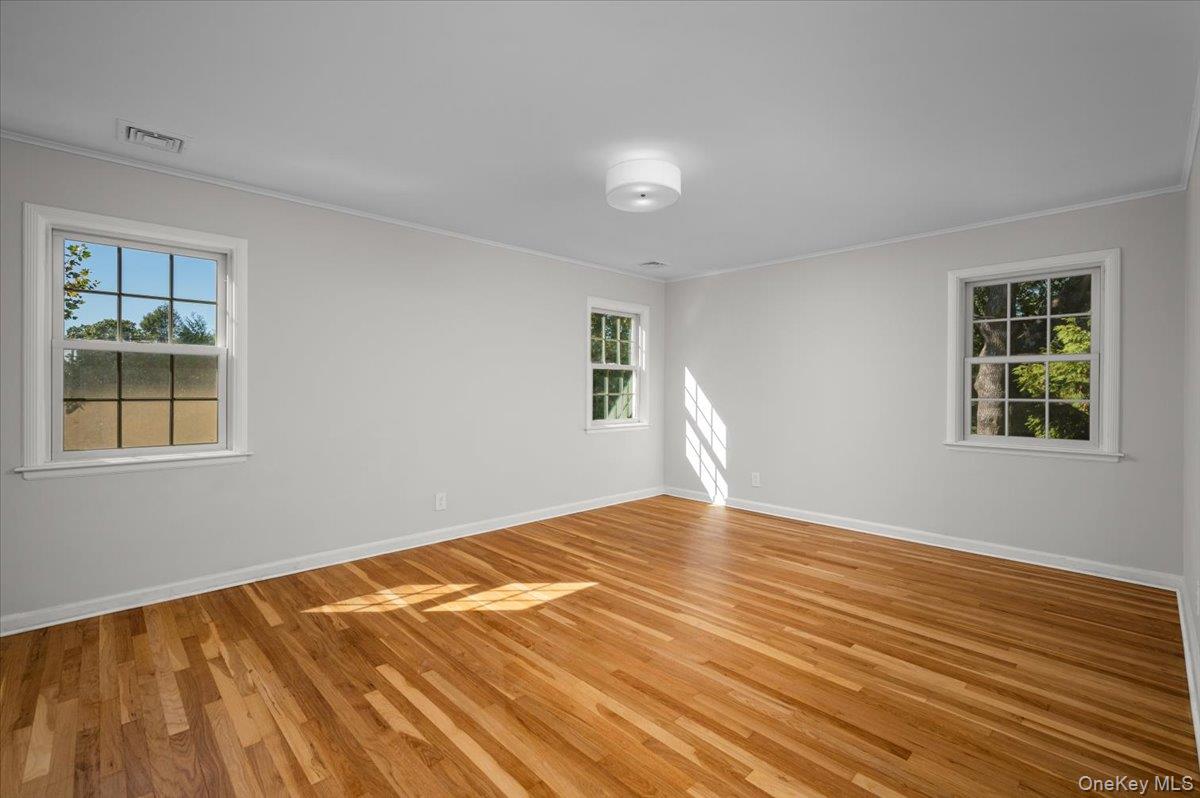 15 Hillside Road Bronxville, NY 10708 - Photo 11 of 30 a view of empty room with wooden floor and fan