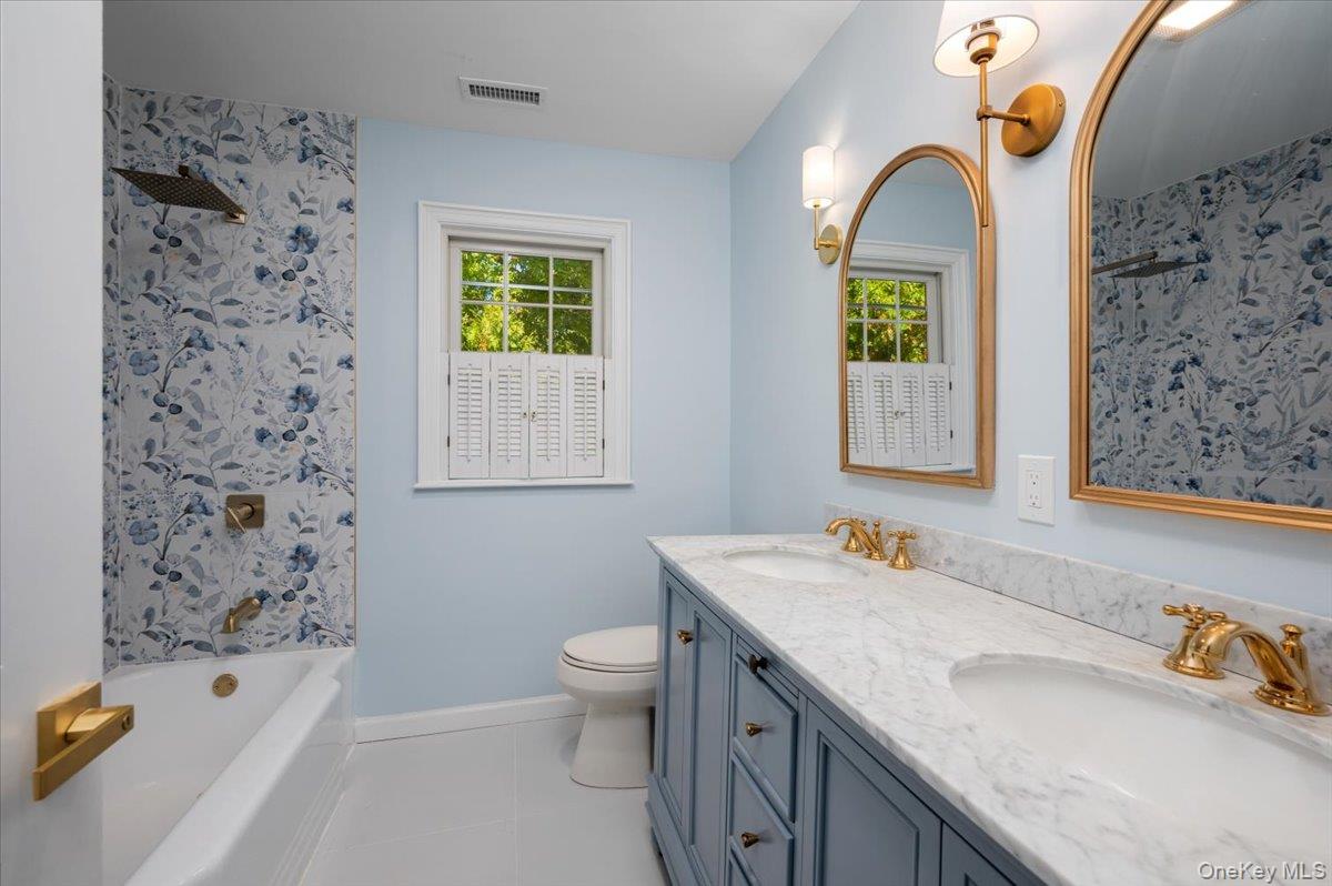 15 Hillside Road Bronxville, NY 10708 - Photo 16 of 30 a bathroom with a granite countertop sink a toilet and shower