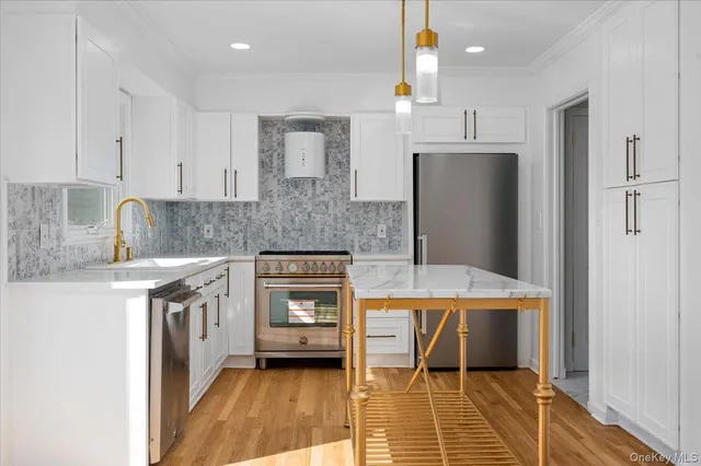 a kitchen with stainless steel appliances granite countertop a sink stove and refrigerator