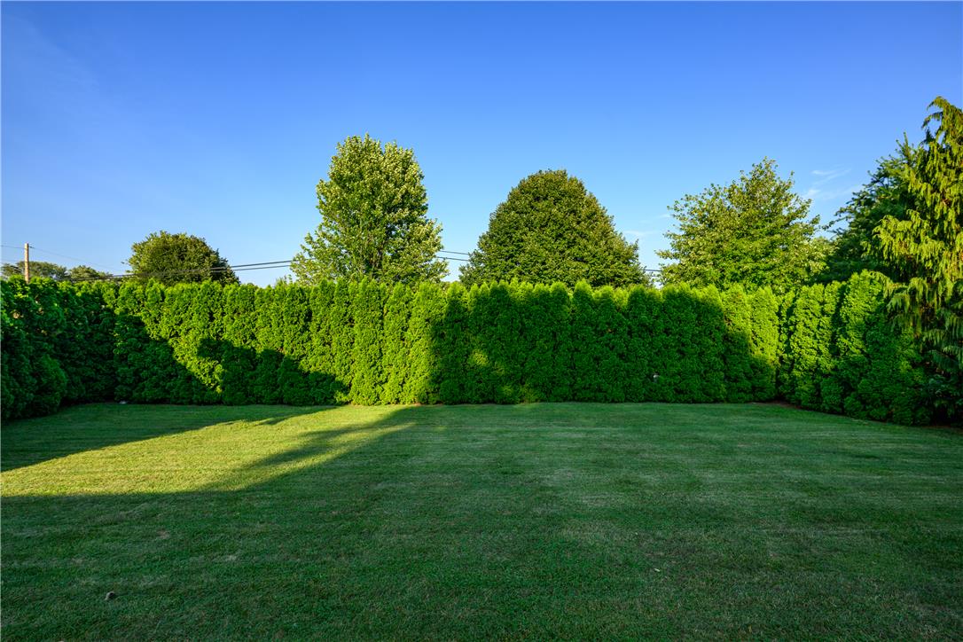 1644 9th Street Bethlehem, PA 18020 - Photo 23 of 27 A verdant privacy hedge encloses a well-maintained lawn, creating a serene outdoor sanctuary.
