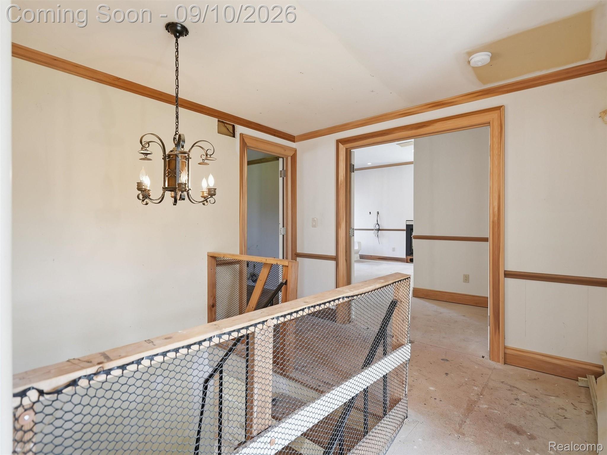 61400 Romeo Plank Road Ray, MI 48096 - Photo 55 of 99 Hardwood trim accents with a decorative chandelier and multiple doorways