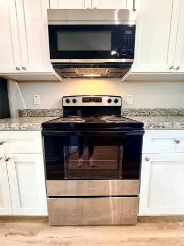 a view of a room with wooden floor and staircase