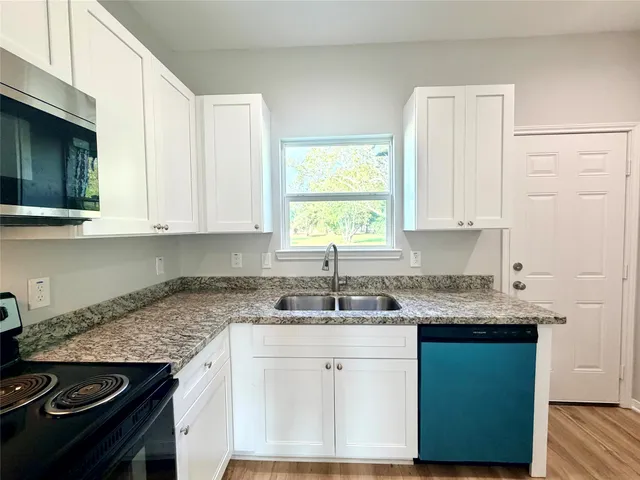 a view of a kitchen with a sink and a stove