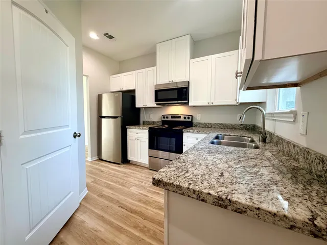 an empty room with windows and closet