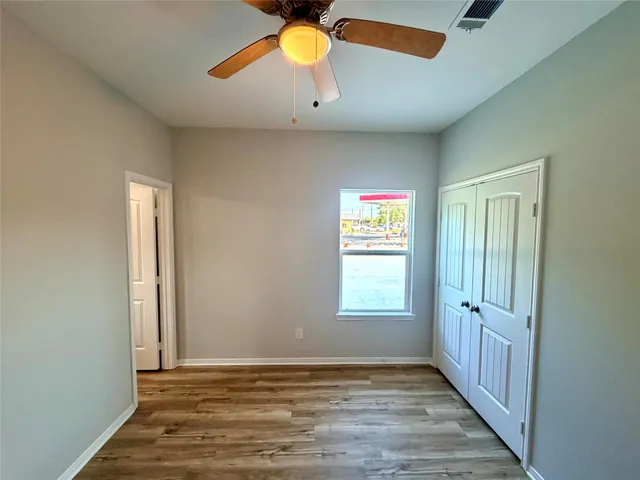 a bathroom with a granite countertop toilet sink and mirror
