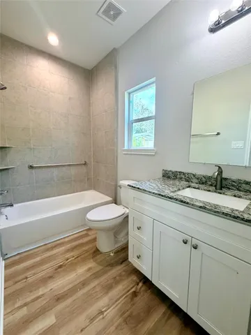 a view of a room with wooden floor