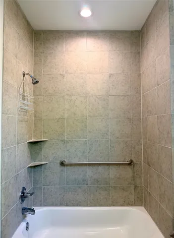 a bathroom with a granite countertop toilet a sink and a mirror