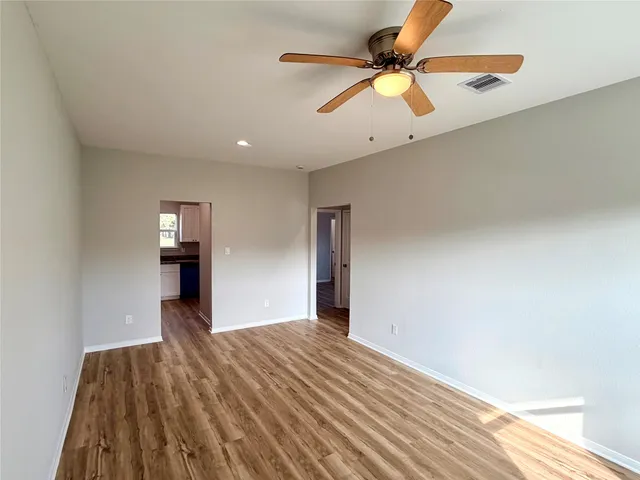 a kitchen with granite countertop white cabinets and appliances