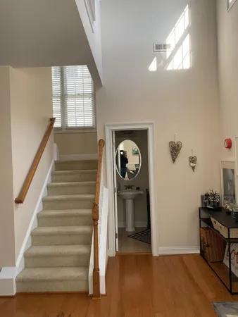 a view of entryway with stairs and wooden floor