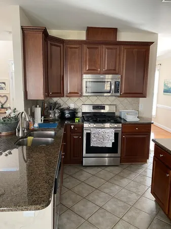 a kitchen with a stove a sink and a microwave