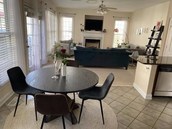 a view of a dining room with furniture and a potted plant