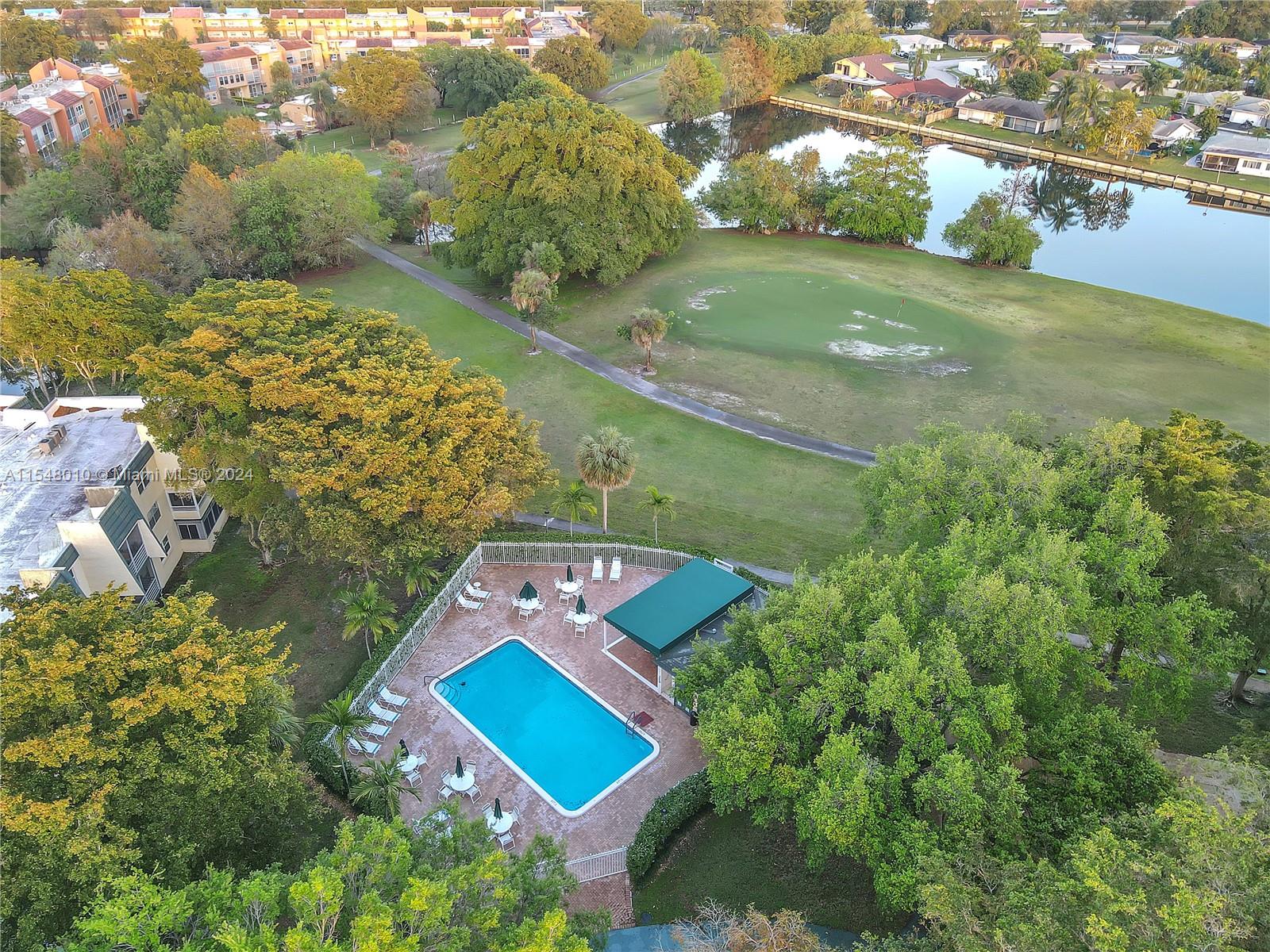 an aerial view of a house with yard swimming pool and outdoor seating