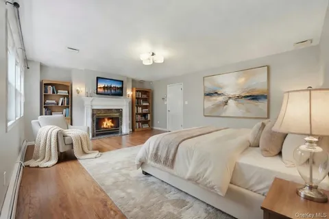 a bedroom with a bed and a fireplace