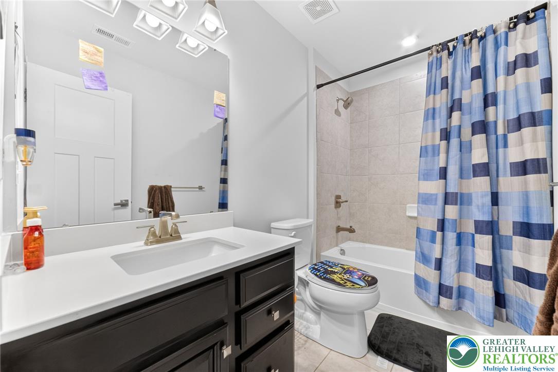 3952 Orth Street Bethlehem, PA 18020 - Photo 31 of 60 A well-lit bathroom with a vanity and a shower-tub combination for daily routines.