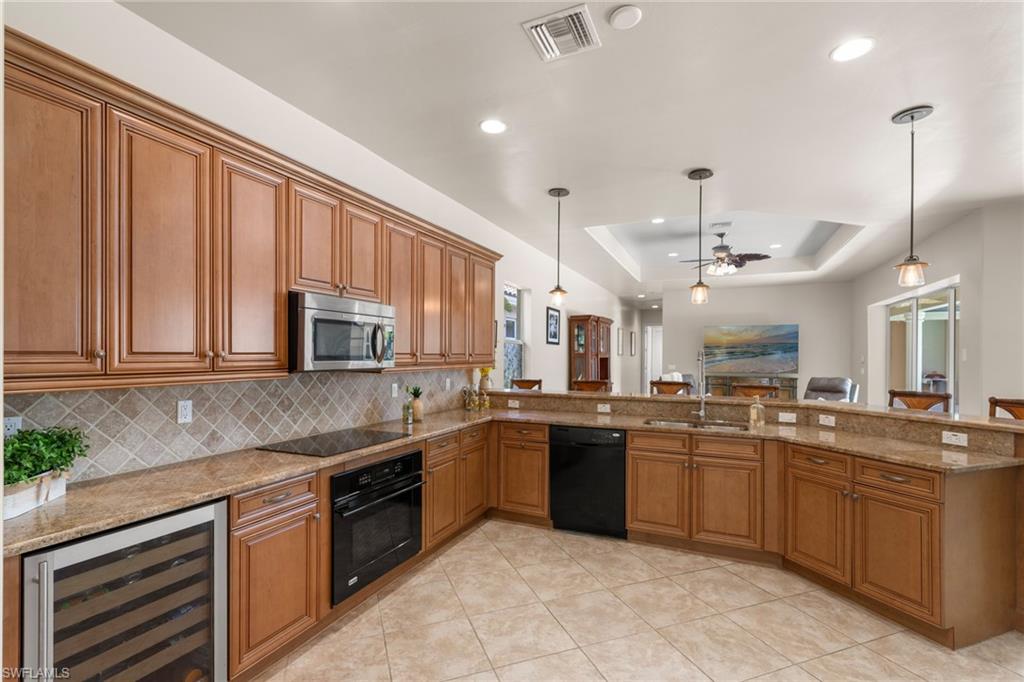 20060 Markward Crossing Estero, FL 33928 - Photo 22 of 50 a kitchen with lots of counter top space a sink and appliances