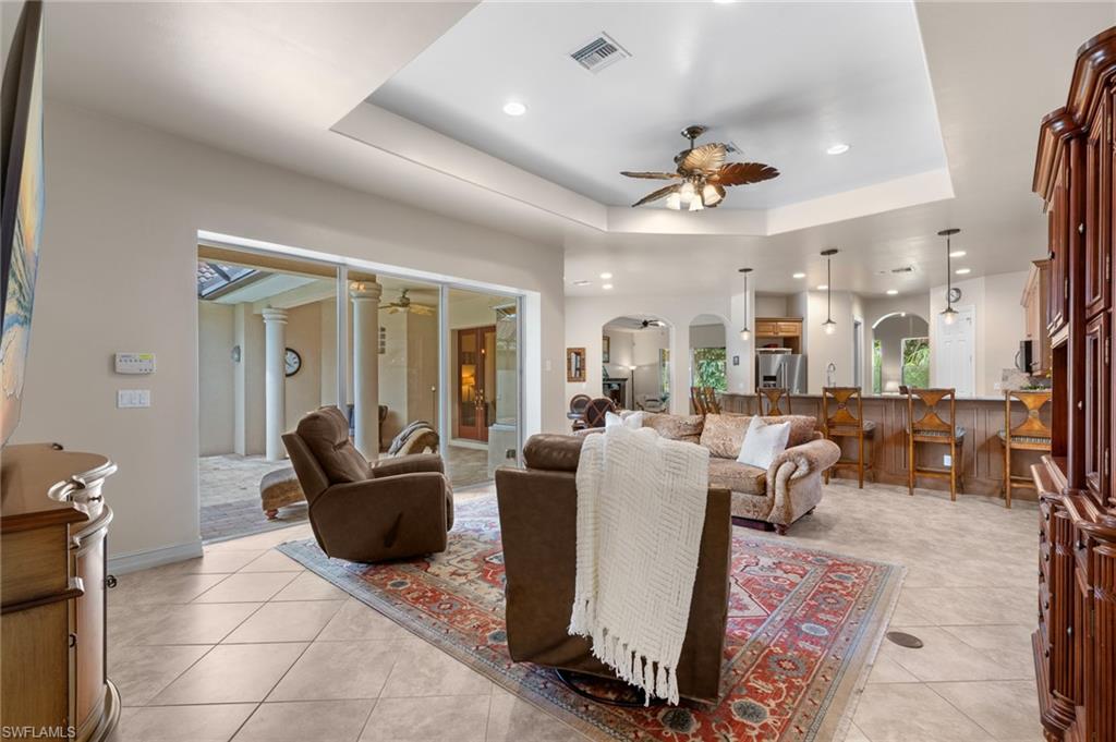 20060 Markward Crossing Estero, FL 33928 - Photo 28 of 50 a living room with furniture a chandelier and a rug