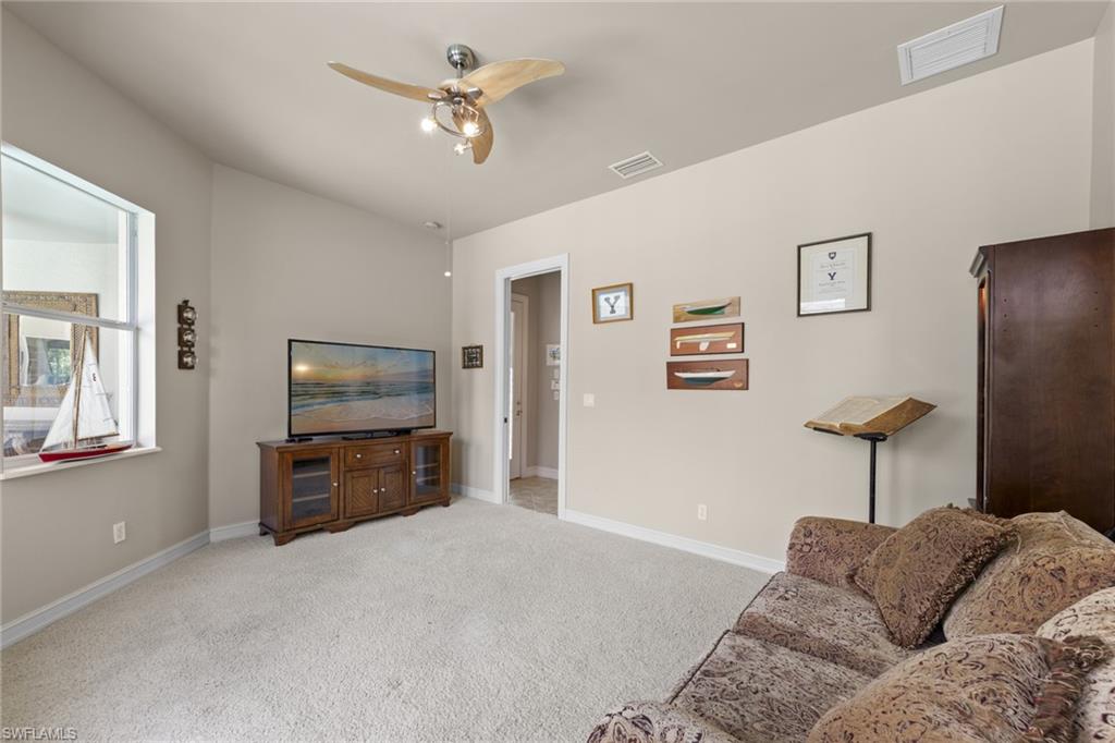 20060 Markward Crossing Estero, FL 33928 - Photo 38 of 50 a living room with furniture a couch and a flat screen tv
