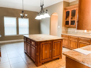 1306 Keenland Road Corpus Christi, TX 78418 - Photo 16 of 26 a kitchen with a stove kitchen island a sink granite counter tops and a living room view
