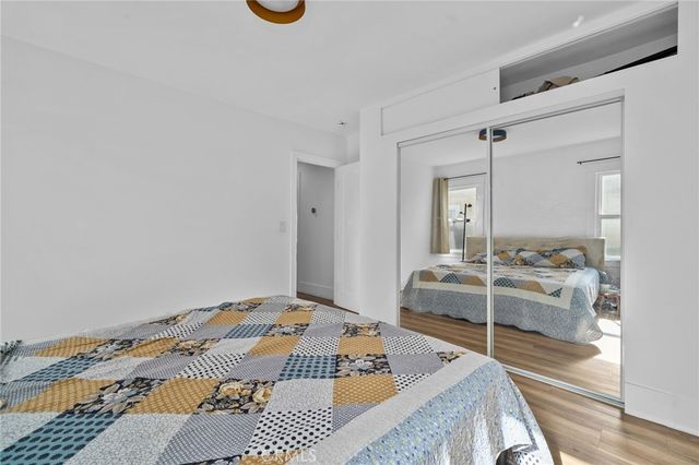 a bedroom with a bed and a mirror