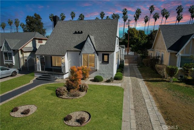 a front view of a house with a yard table and a fire pit