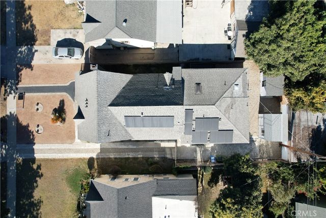 an aerial view of a house with a yard