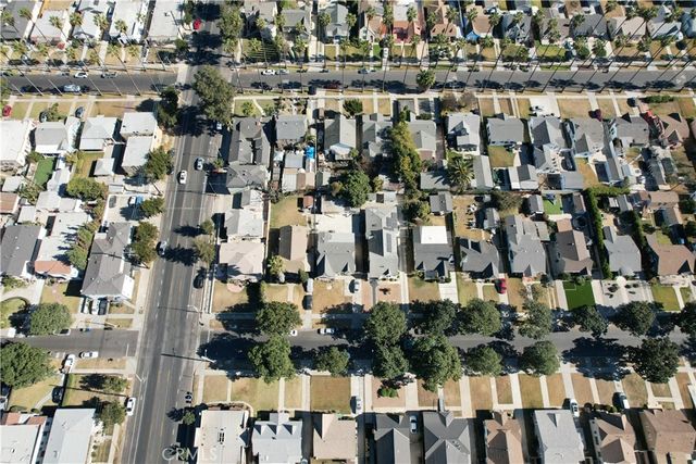 an aerial view of residential houses with city view