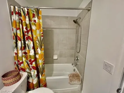 a bathroom with a shower and a toilet