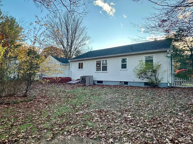a view of a house with a yard and hanging chair