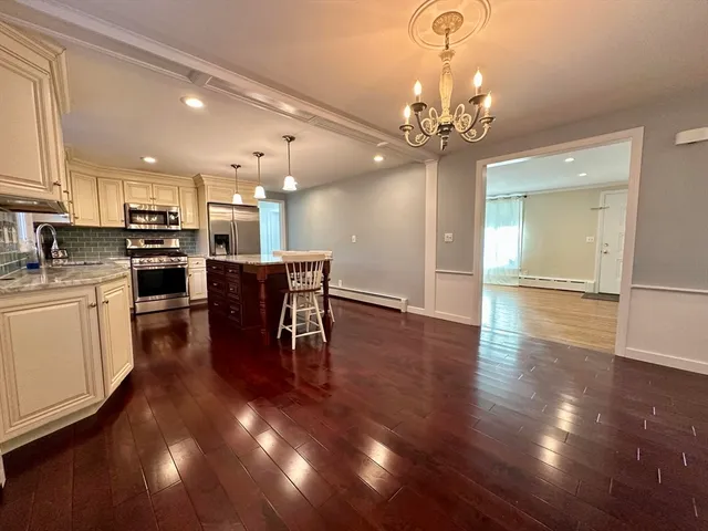 a view of a dining room with furniture wooden floor and chandelier