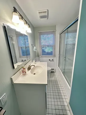 a bathroom with a sink a mirror and a bathtub