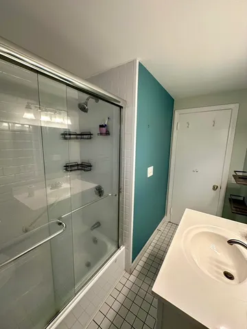 a bathroom with a shower and a sink