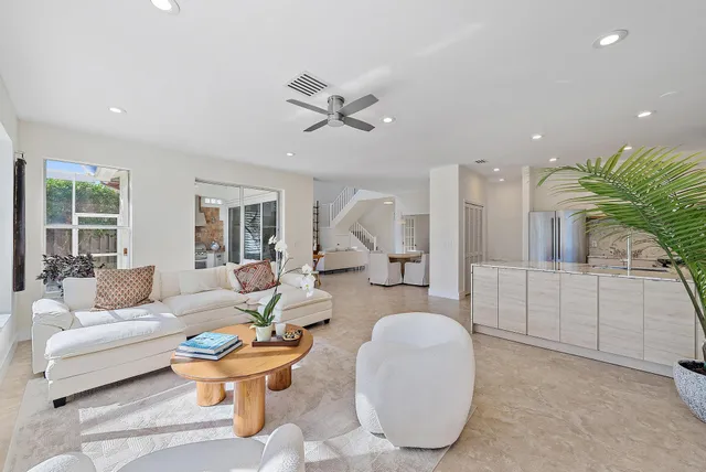 a bedroom with a bed a chandelier and a window