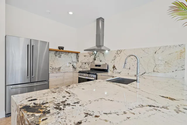 an aerial view of a house with a garden and lake view