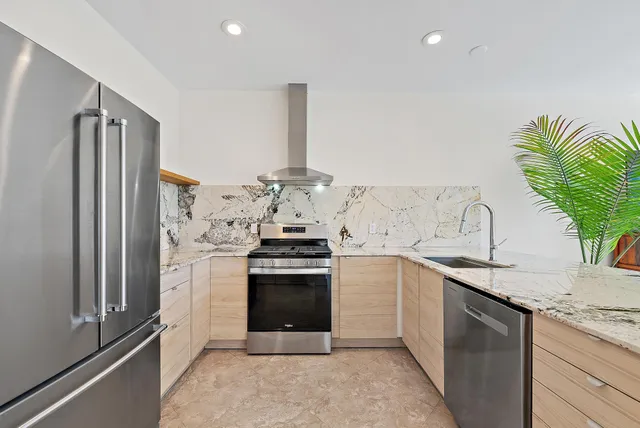 an aerial view of residential houses with outdoor space and river