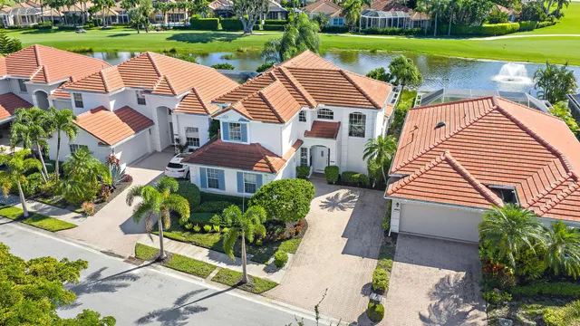 an aerial view of residential houses with outdoor space and river