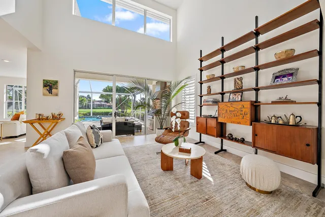 a living room with furniture a rug and a large window