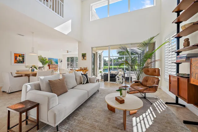 a living room with furniture and a floor to ceiling window