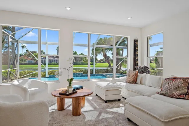 a dining hall with stainless steel appliances granite countertop a sink and a large window