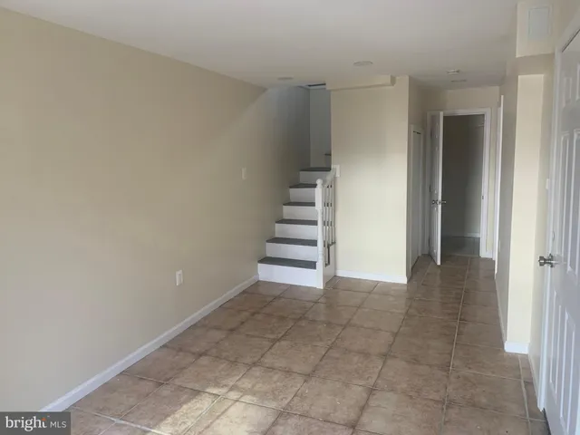 a view of an empty room with stairs and ventilation