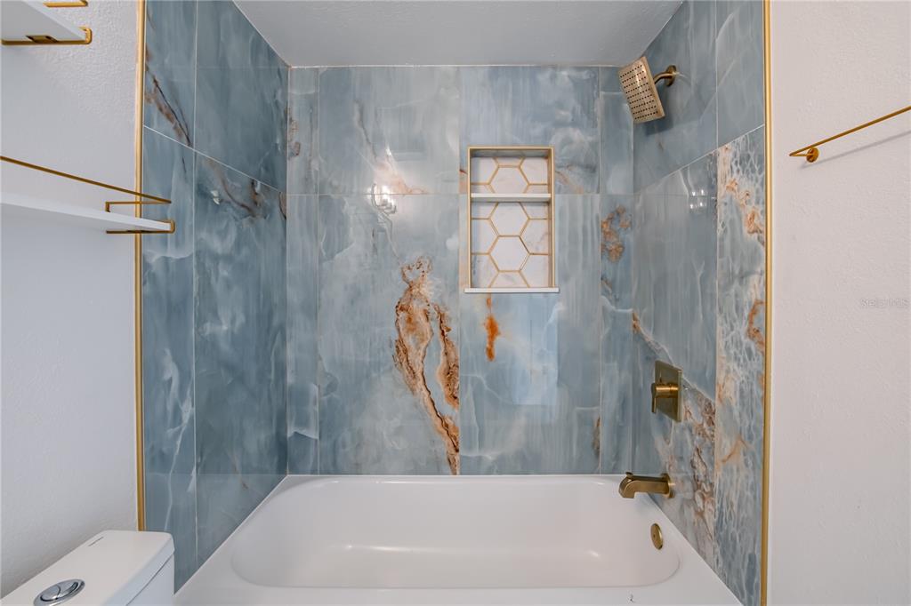 616 Highview Circle North Brandon, FL 33510 - Photo 14 of 41 a bathroom with a tub and a shower