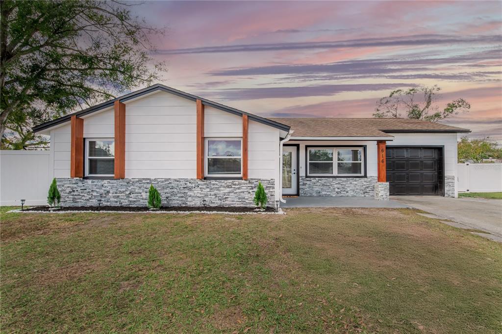 616 Highview Circle North Brandon, FL 33510 - Photo 40 of 41 a front view of a house with a garden and yard