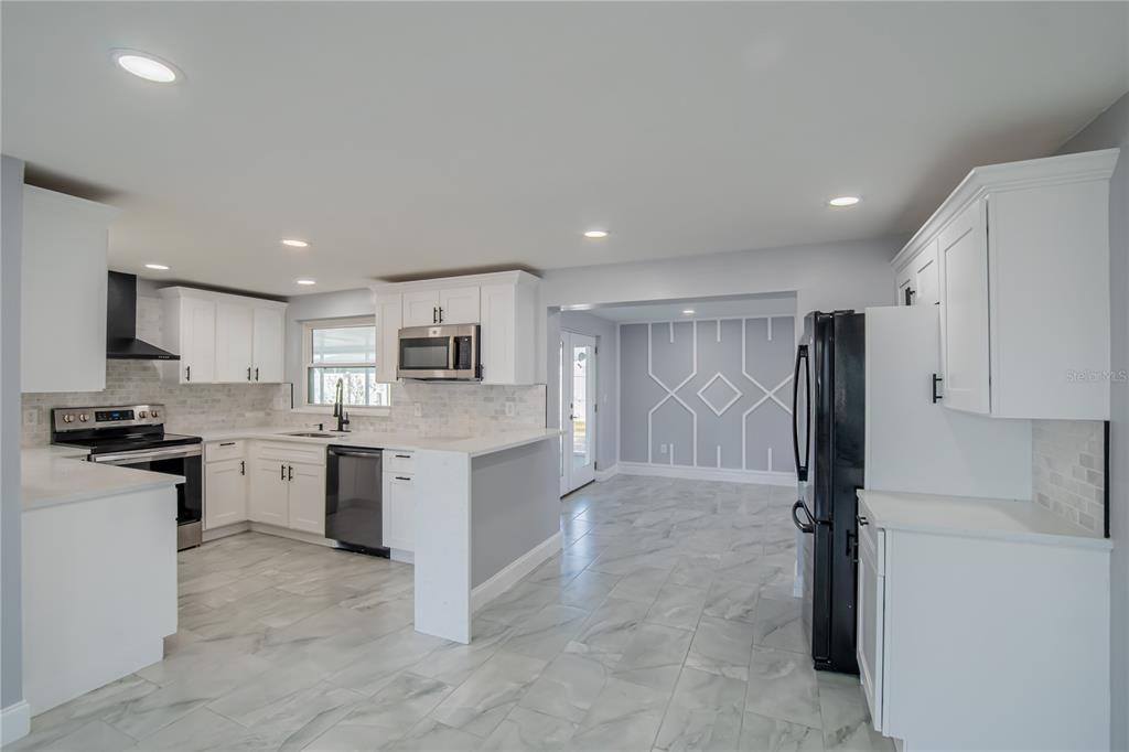 616 Highview Circle North Brandon, FL 33510 - Photo 4 of 41 a kitchen with a refrigerator and a stove top oven