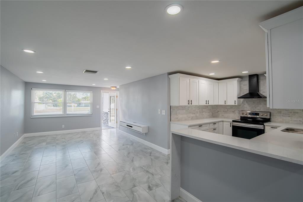 616 Highview Circle North Brandon, FL 33510 - Photo 5 of 41 a view of a kitchen with a sink and dishwasher a stove top oven with wooden floor