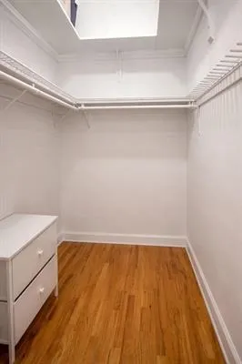 a room with a wooden floor and white walls