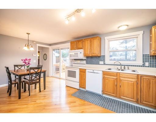 44 Corey Road Springfield, MA 01128 - Photo 11 of 29 a kitchen with stainless steel appliances granite countertop a stove top oven a sink dishwasher and white cabinets with wooden floor
