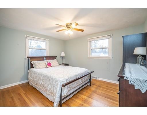 44 Corey Road Springfield, MA 01128 - Photo 15 of 29 a bedroom with a bed and a chandelier