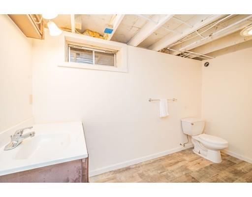 44 Corey Road Springfield, MA 01128 - Photo 20 of 29 a bathroom with a sink a toilet and a mirror